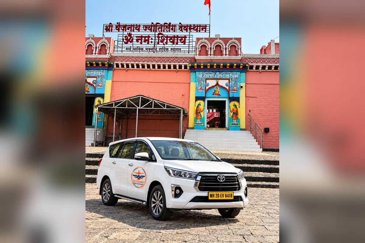 Shri Vaijnath Jyotirlinga temple entrance at Parli with a Sai Sameer Tours and Travels Innova Crysta