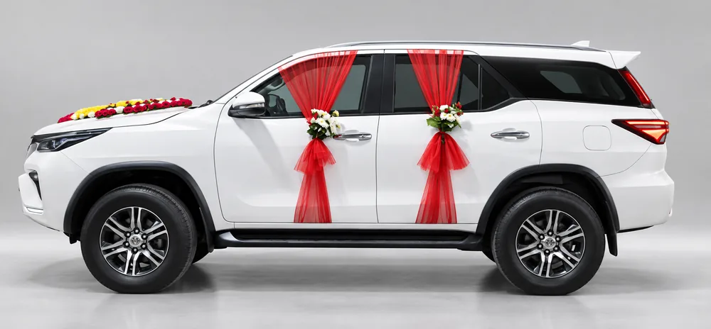 Toyota Fortuner decorated with ribbons for a wedding